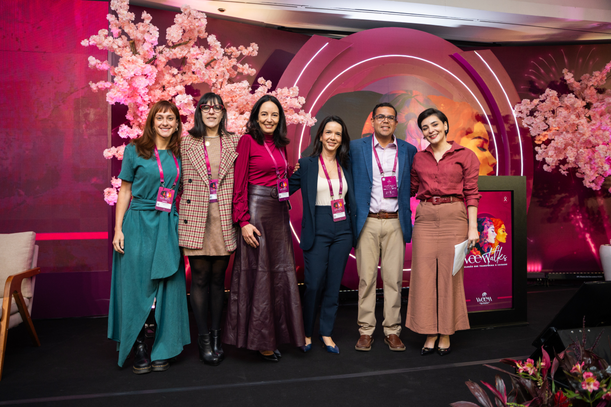 Seis participantes posam juntas no palco do WEEM Talks 2026 após uma atividade do evento.